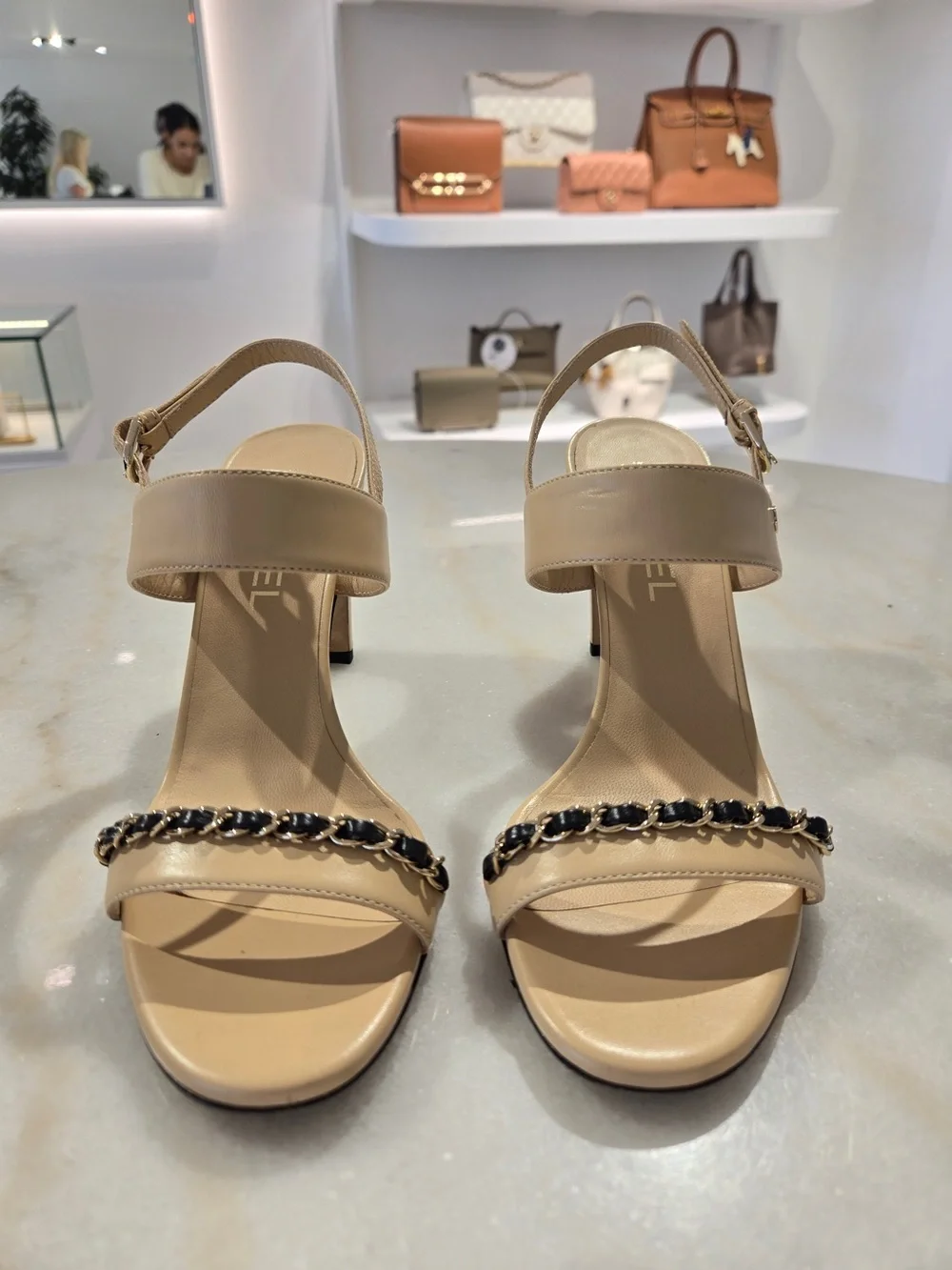 CHANEL Beige Slingback Heels with Black-and-Gold Chain